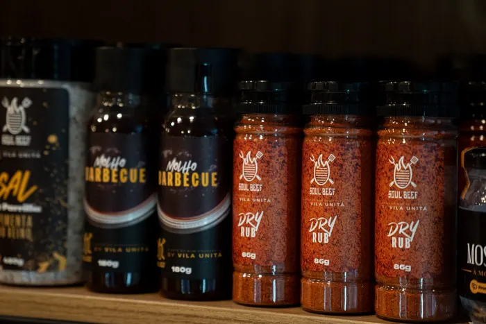 Prateleira com dry rub, molho barbecue e sal de parrilla da Soul Beef